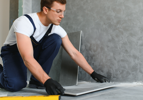 Hands typing on a laptop to schedule a flooring consultation online.